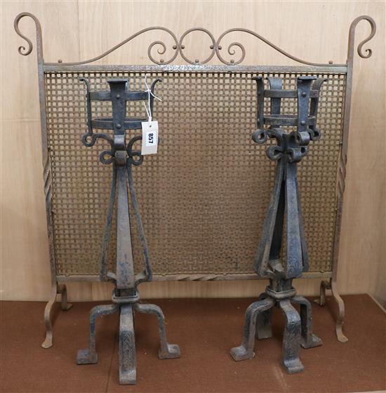 A pair of wrought iron firedogs and a firescreen W.85cm